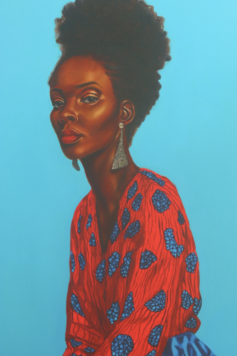 Portrait of a Black woman in a red patterned garment against a bright cyan background