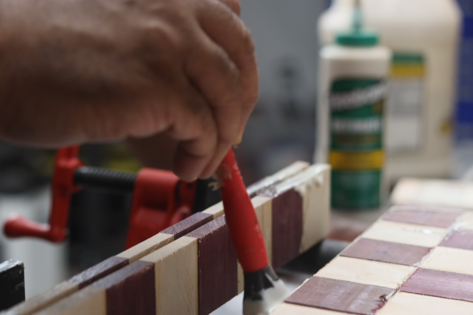 Carl gluing up alternating light and dark squares for a checkerboard cutting board