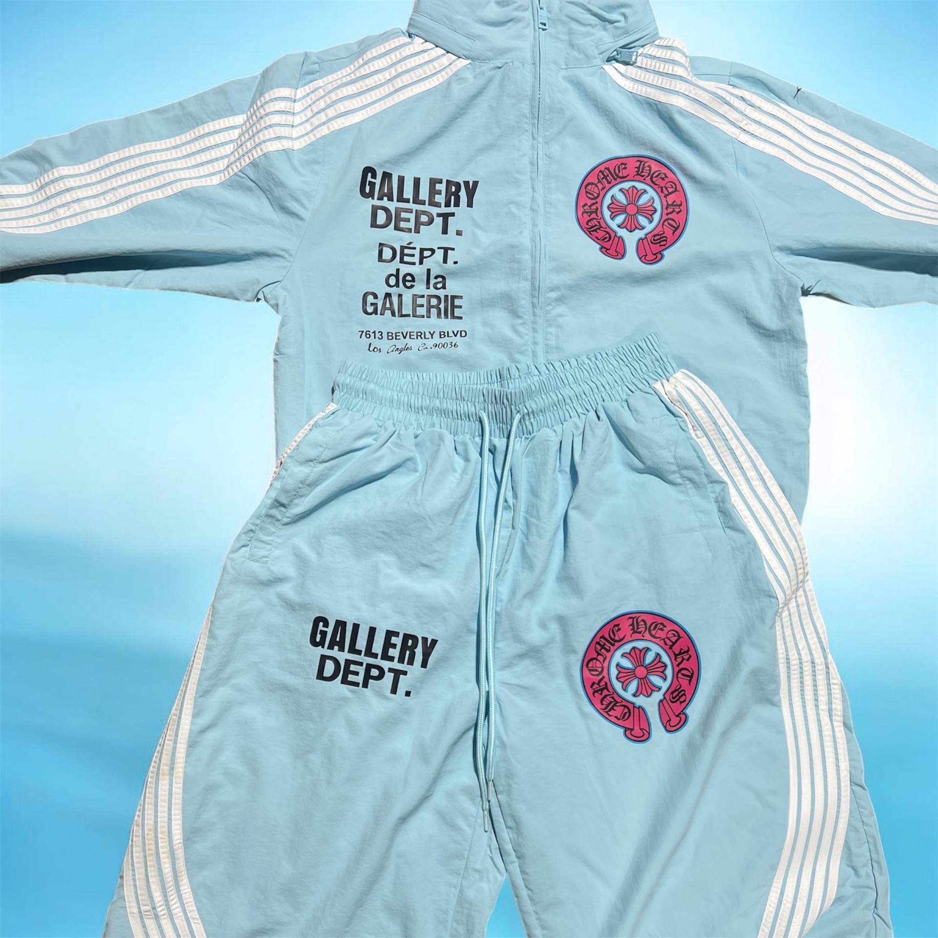Powder blue tracksuit with bold graphic prints on the jacket and pants
