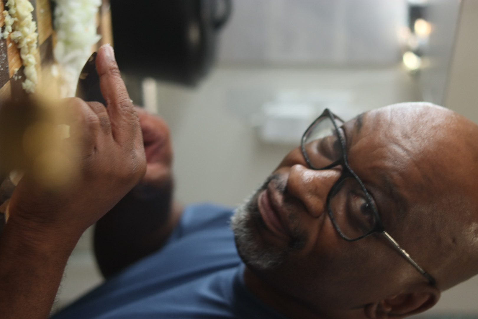 Carl Tyler working closely on a small wooden detail in the shop